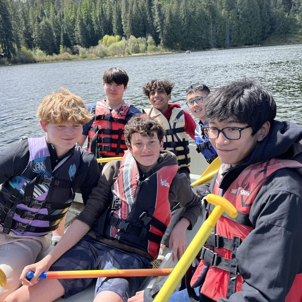 Kids on a raft having fun and smiling together.